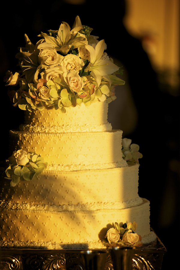 White wedding cake with white floral cake topper - photo by top Atlanta-based wedding photographer Scott Hopkins Photography